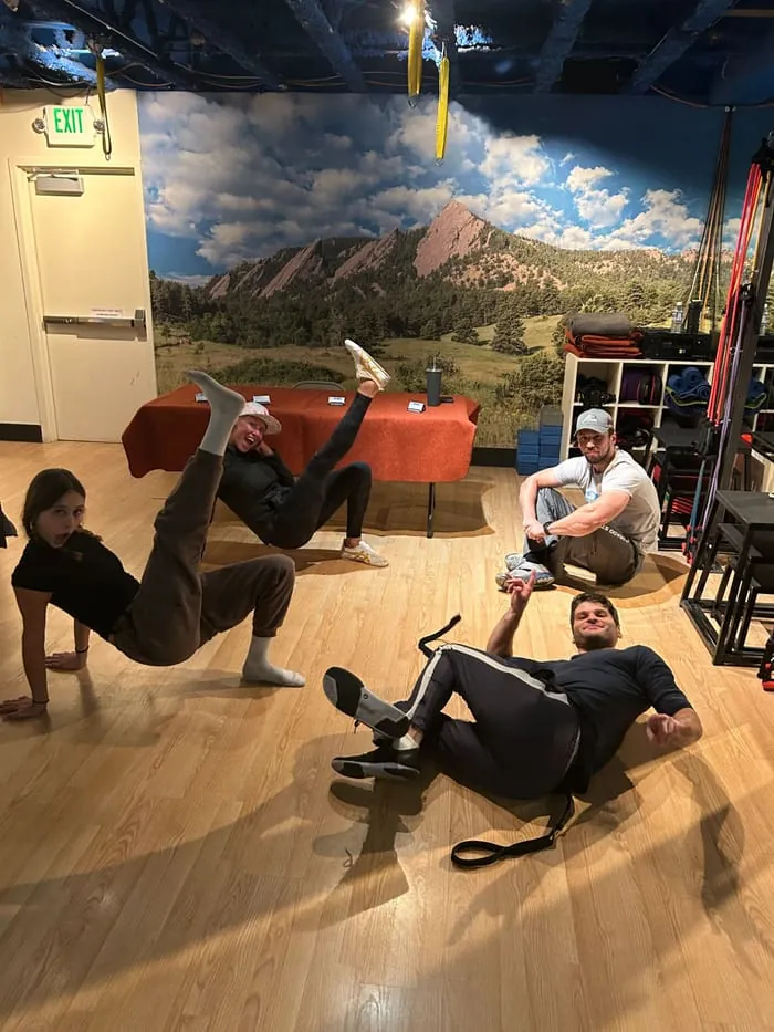 A group class working on the studio floor